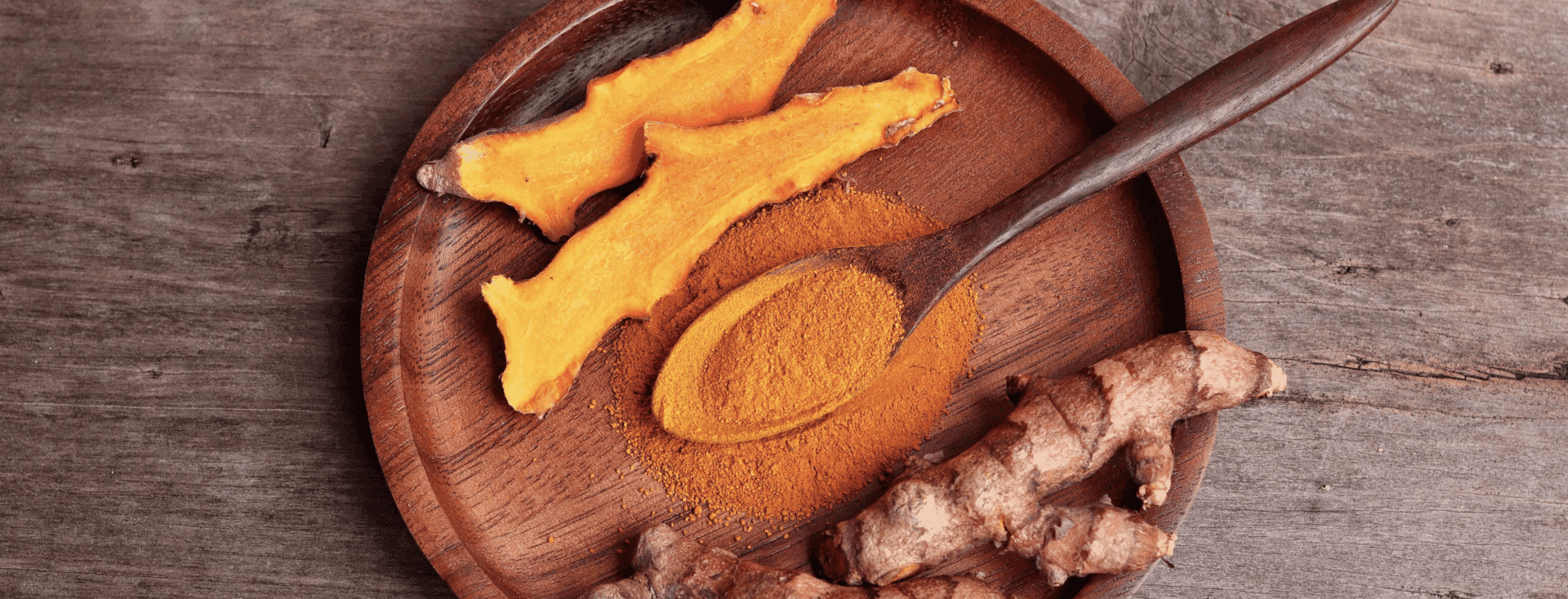 roots and powder of turmeric on a plate
