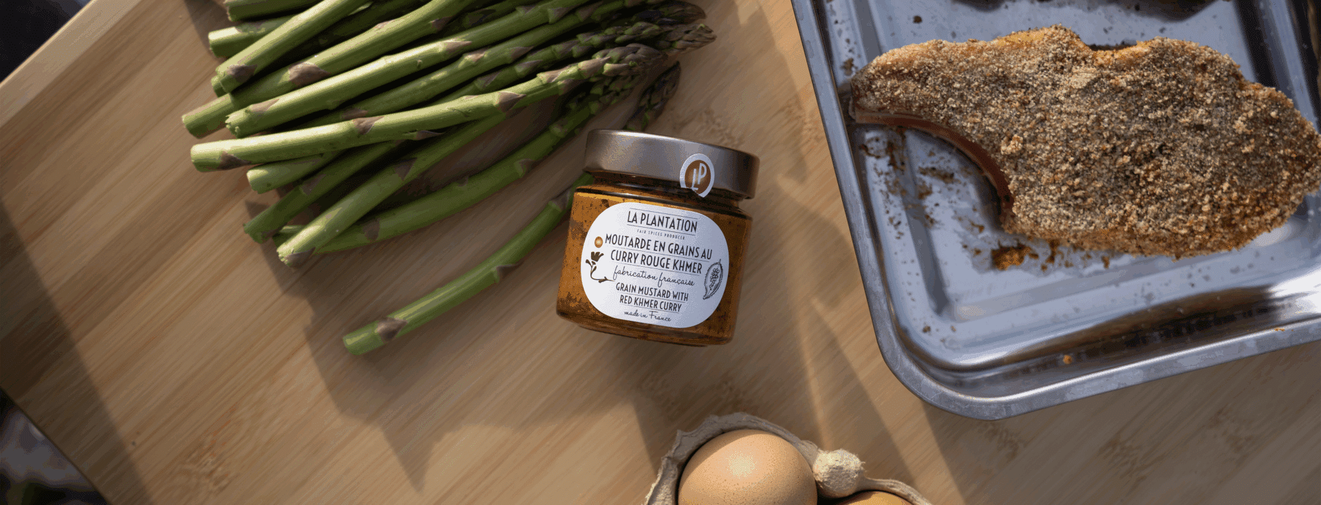 scattered asparagus spears and a jar of mustard